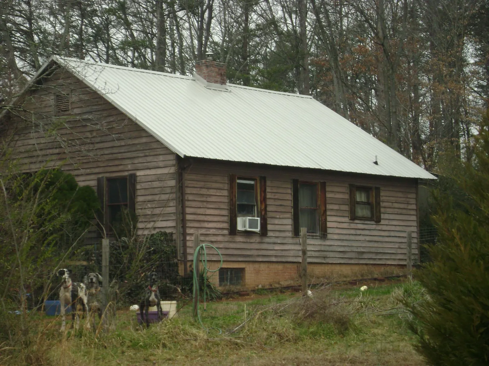 White metal roof on an old wood sided farmhouse, from a Metal Roof Installation job in Burlington